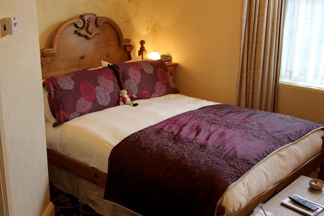 Double room with purple bedding at Kays Cottage